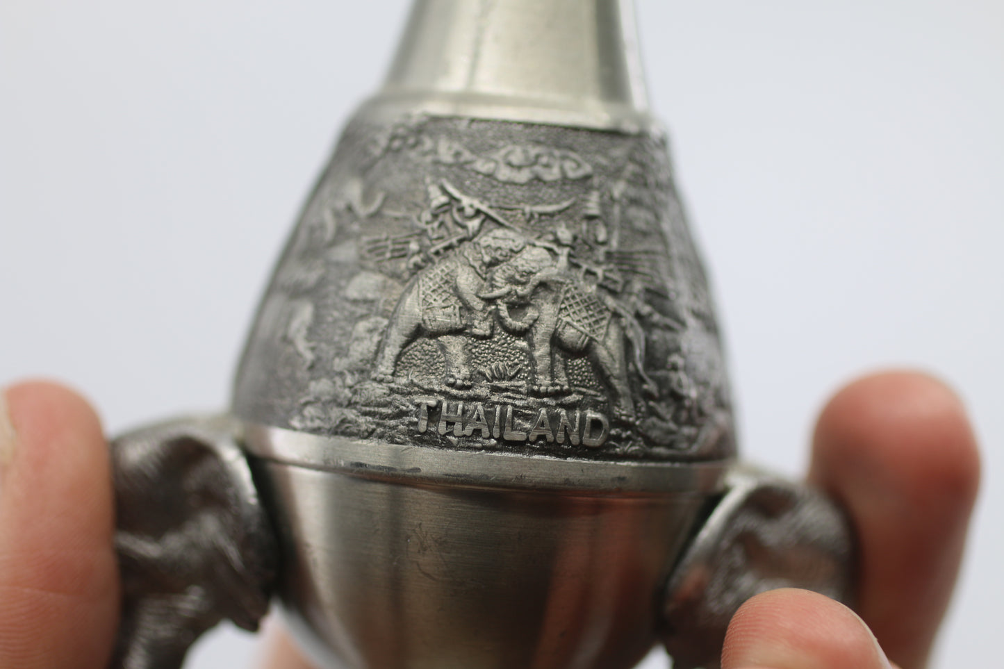 Thai vase in white metal decorated with elephant heads and friezes