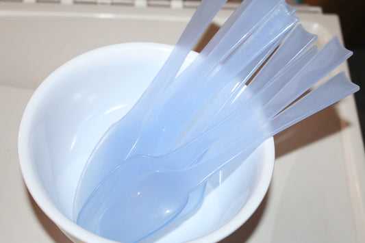 palm tree bowl microwave with a lot of spoons forks knifes plastics