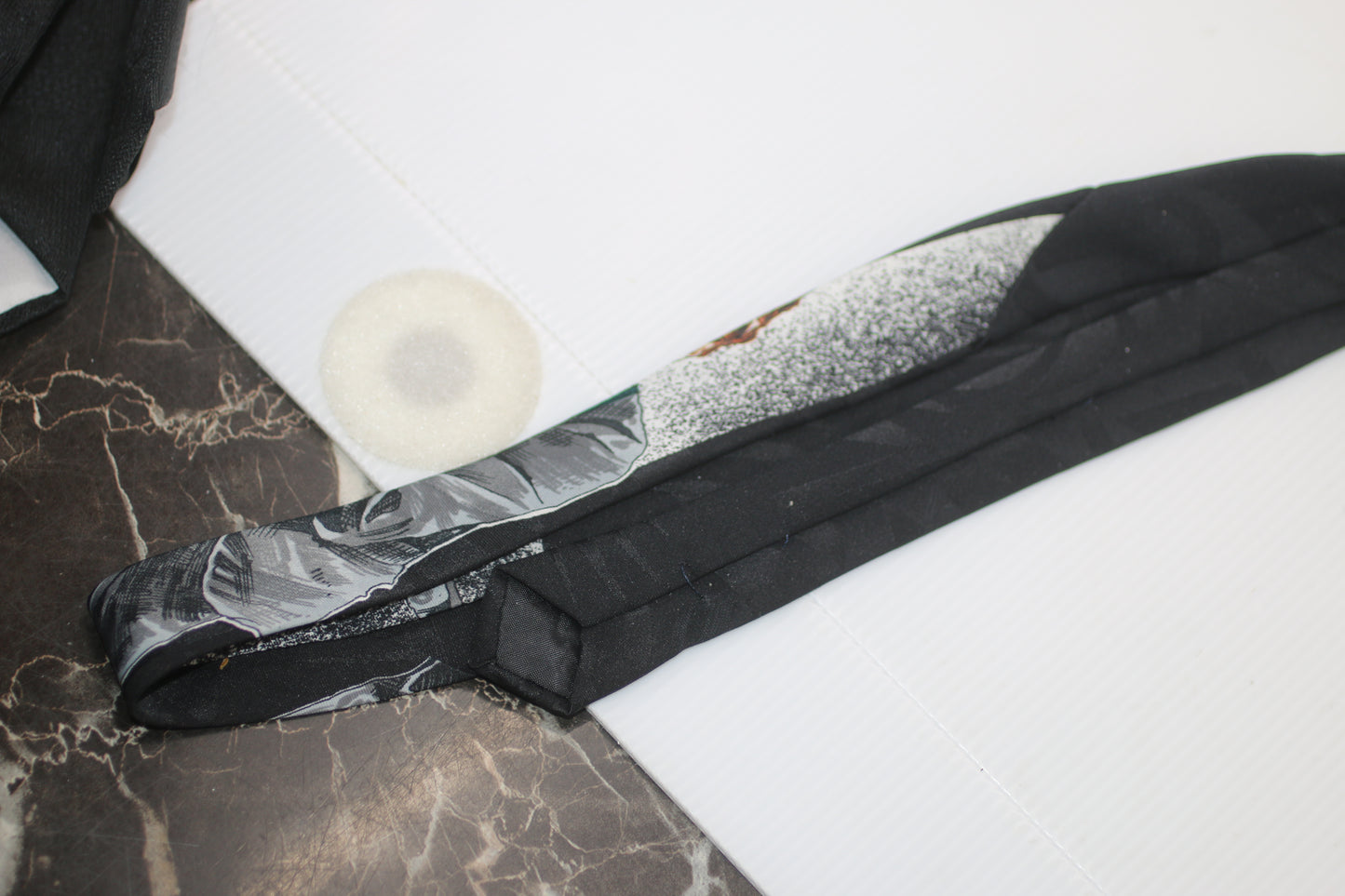 Marbella James Bond style logo drawing on the tie