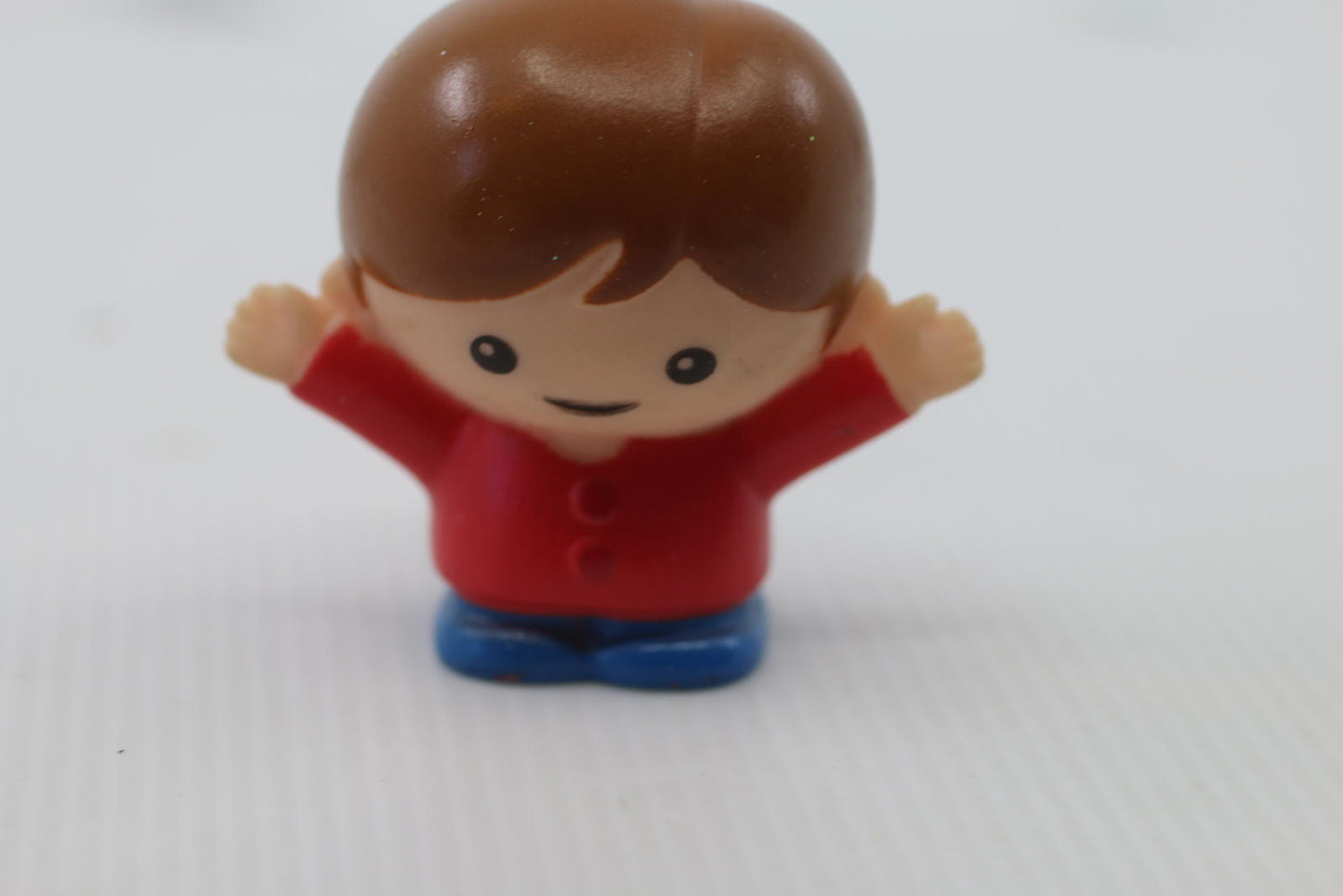 Small Plastic Figurine Toy with Brown Hair and Red Shirt