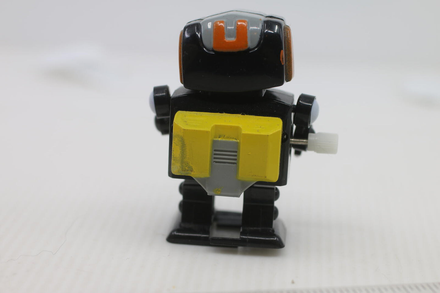 Vintage Wind-Up Robot Toy with Yellow and Red Details