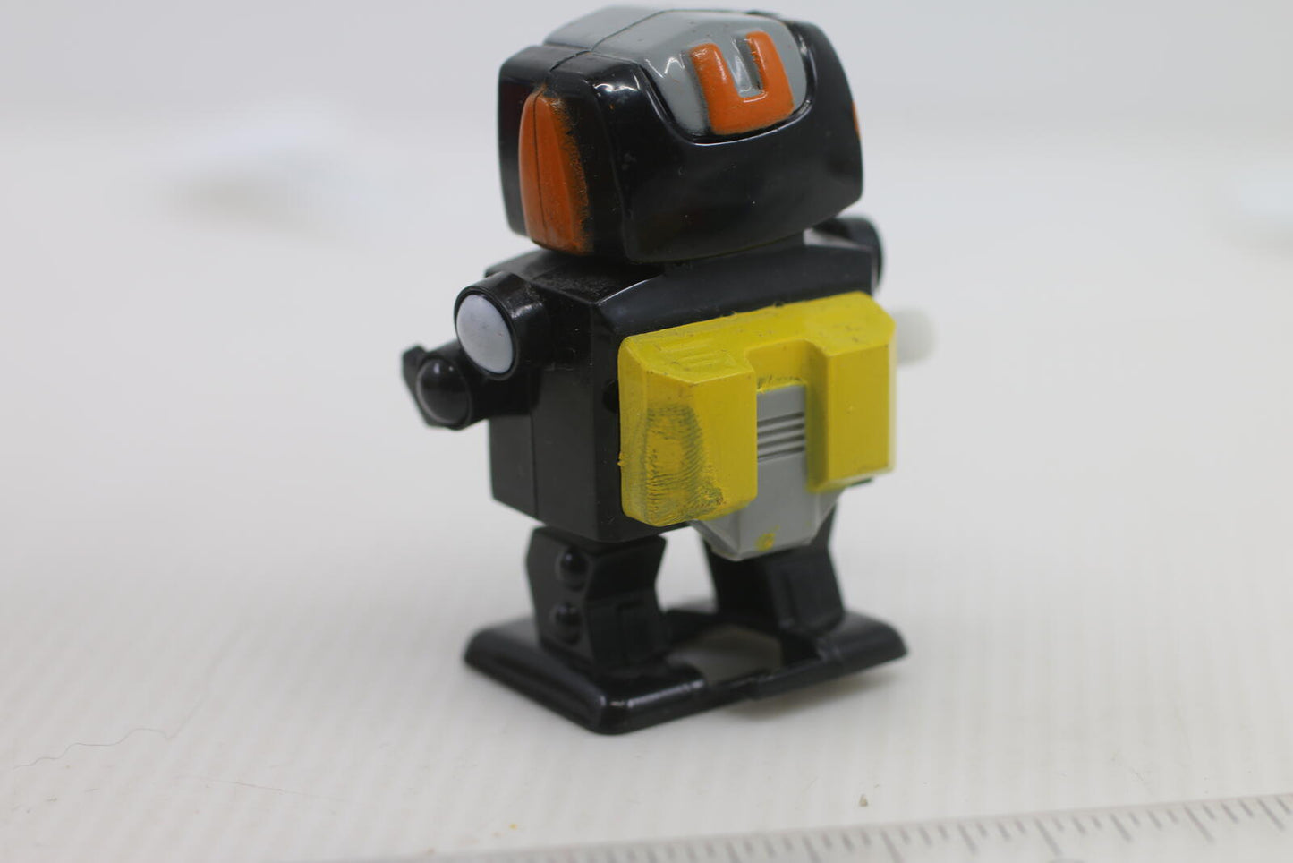 Vintage Wind-Up Robot Toy with Yellow and Red Details