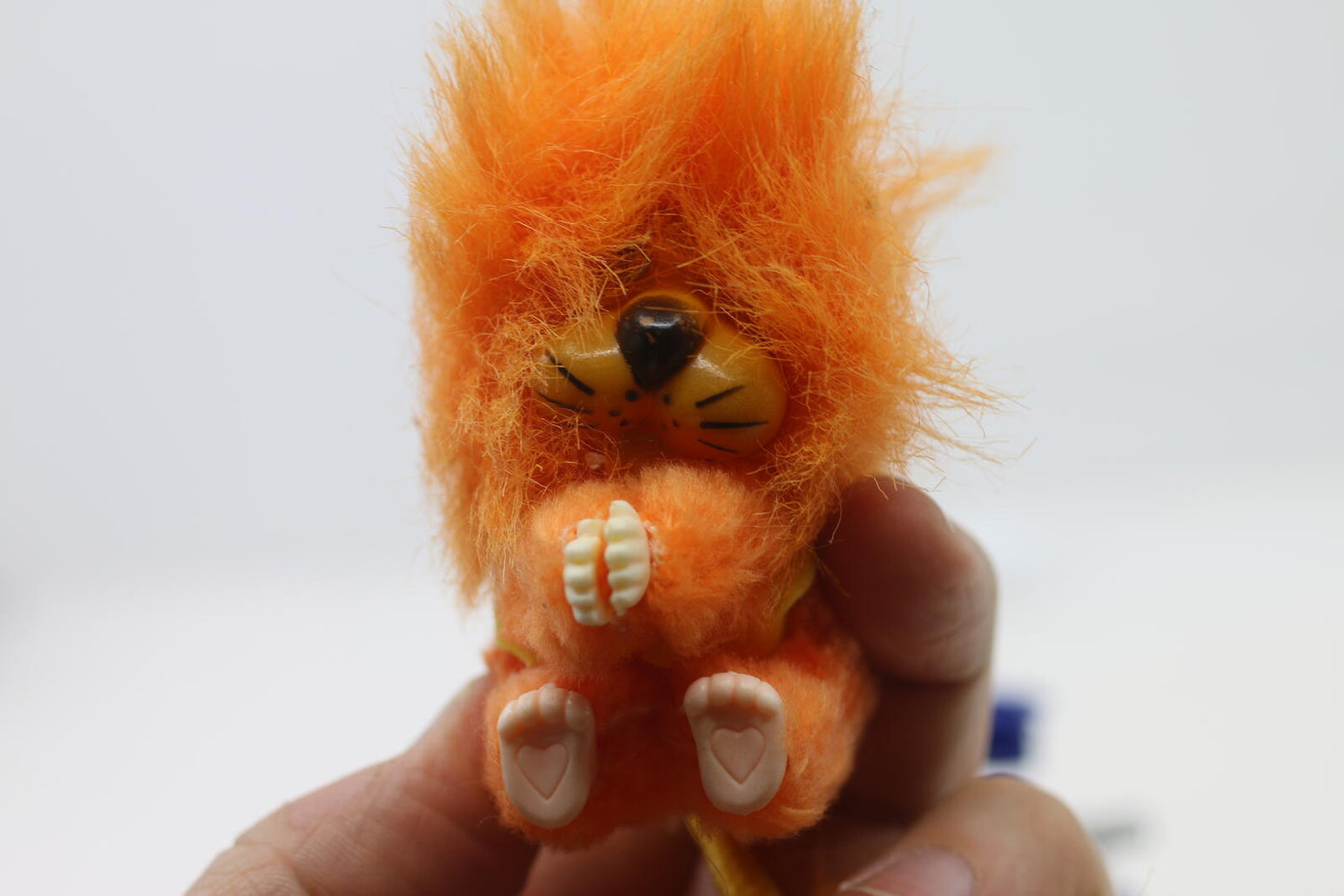 Vintage Orange Fuzzy Lion Figurine Pencil Clip hands
