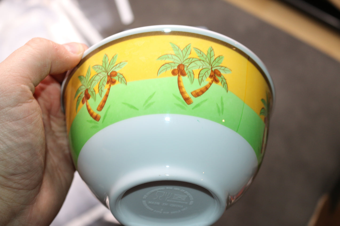 palm tree bowl microwave with a lot of spoons forks knifes plastics