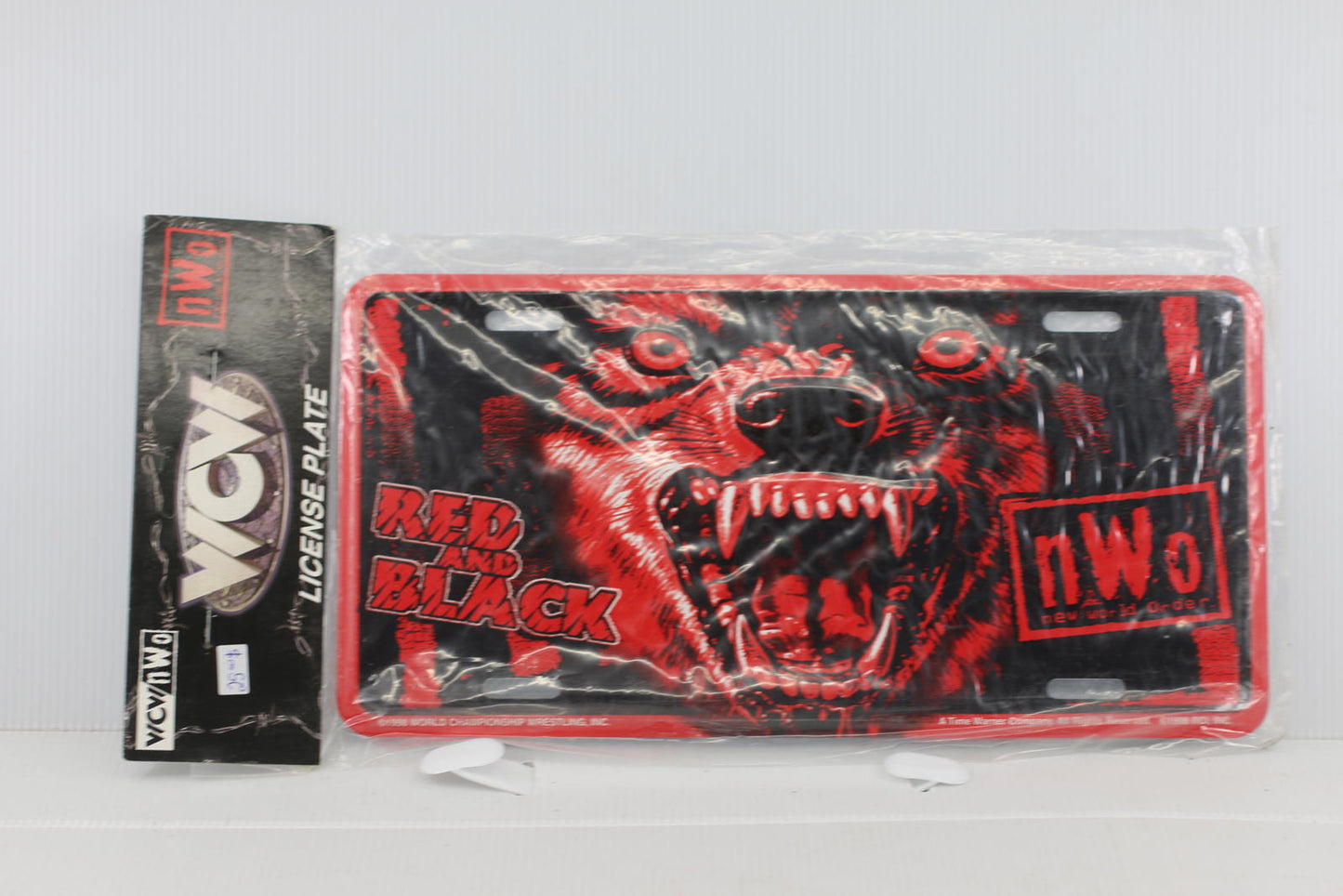Sealed 1998 WCW New World Order Red & Black Wolf Metal Automobile Vehicle Plate