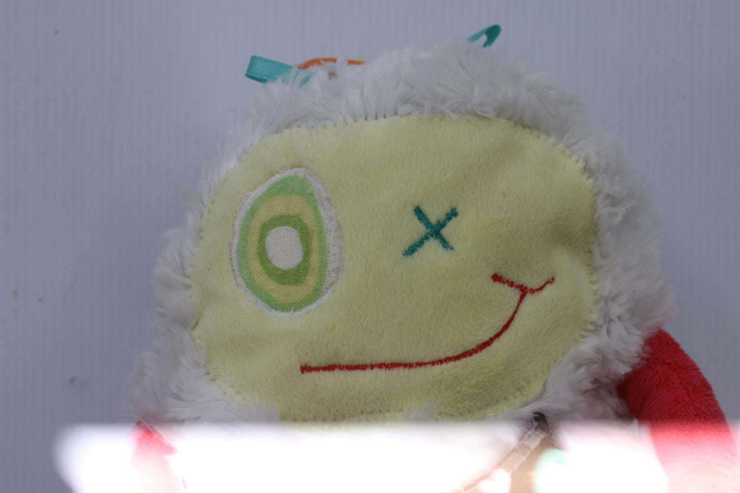 Plush Stuffed Toy with Long Red Limbs and Smiling Face Les Monstres à Câlins