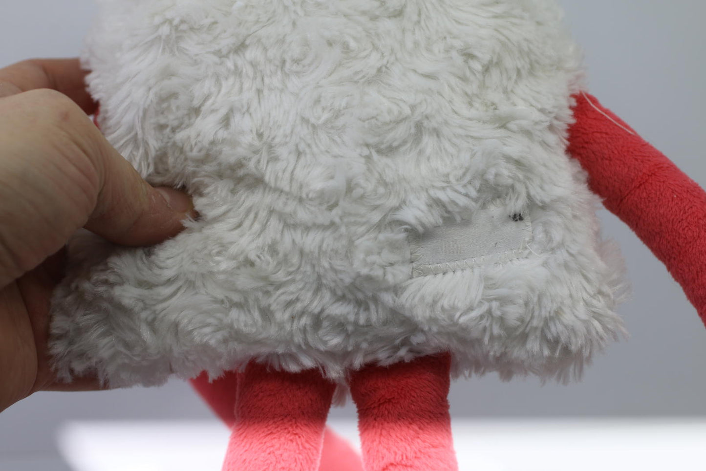 Plush Stuffed Toy with Long Red Limbs and Smiling Face Les Monstres à Câlins