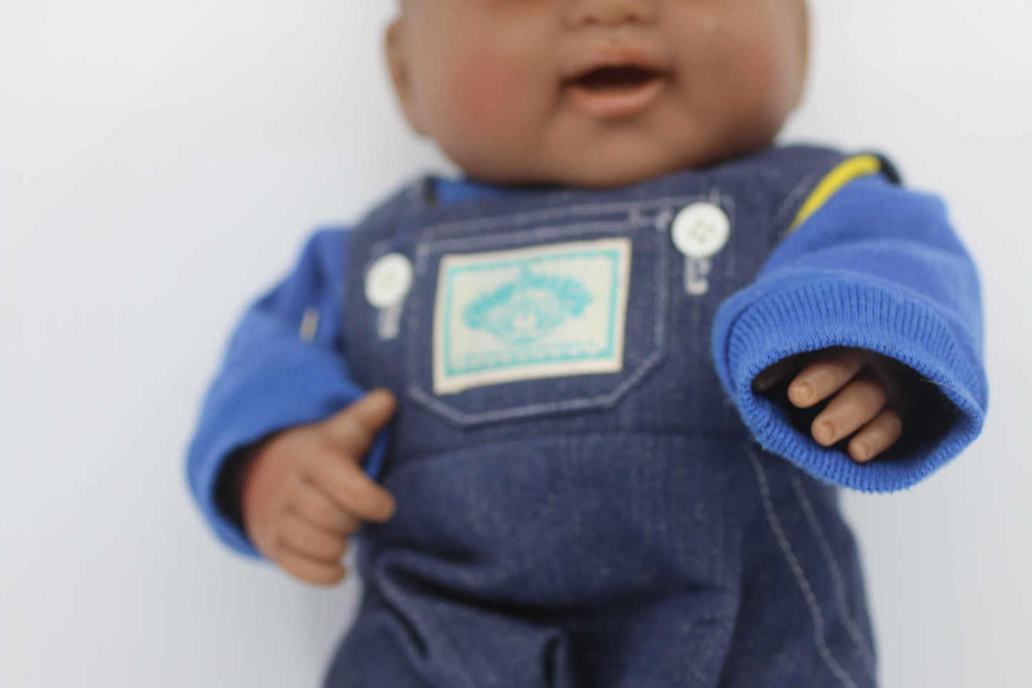 cabbage patch kids cloth on a berenguer african baby doll with red cap