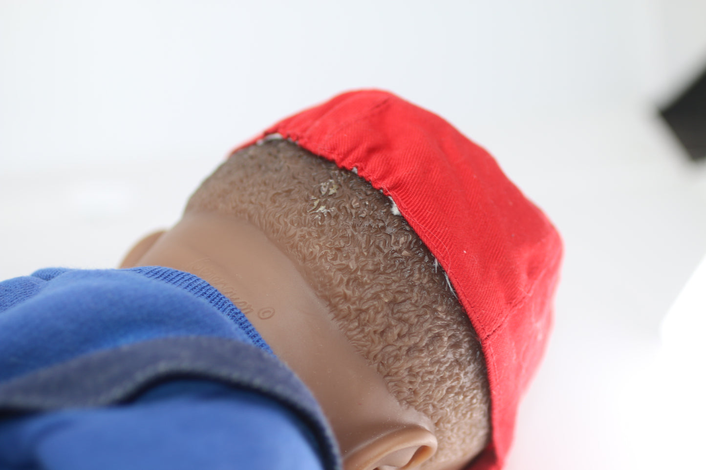 cabbage patch kids cloth on a berenguer african baby doll with red cap